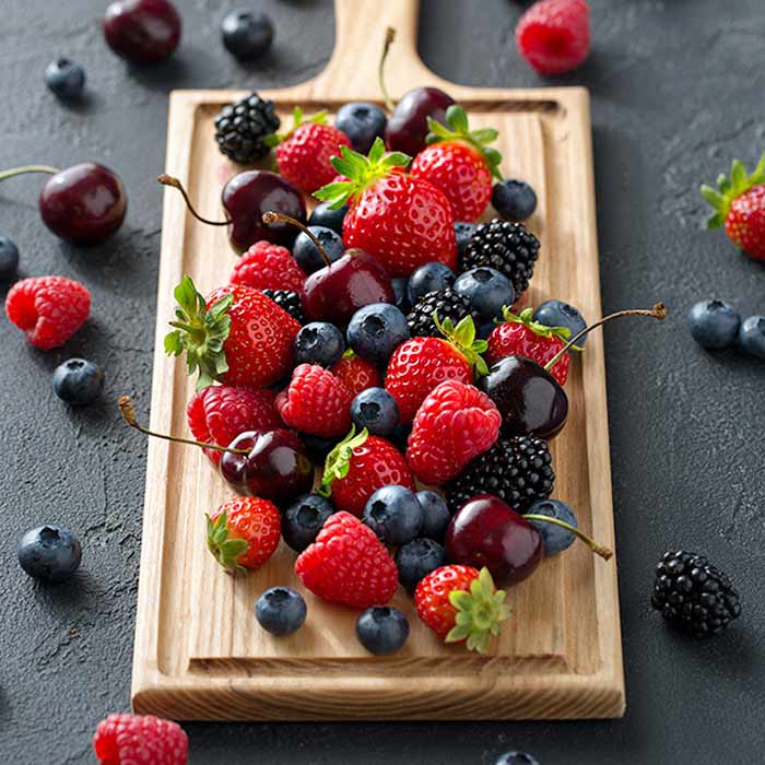 Photo of berries on a wooden board