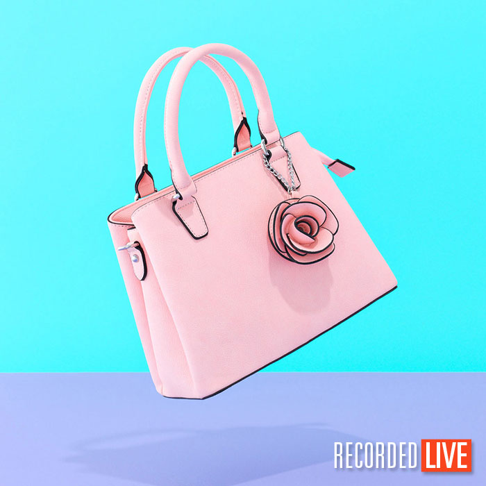 Pink handbag floating on juxtaposing background