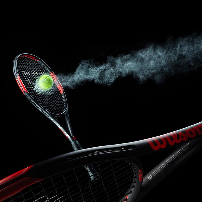 Wilson tennis racket with flying tennis ball
