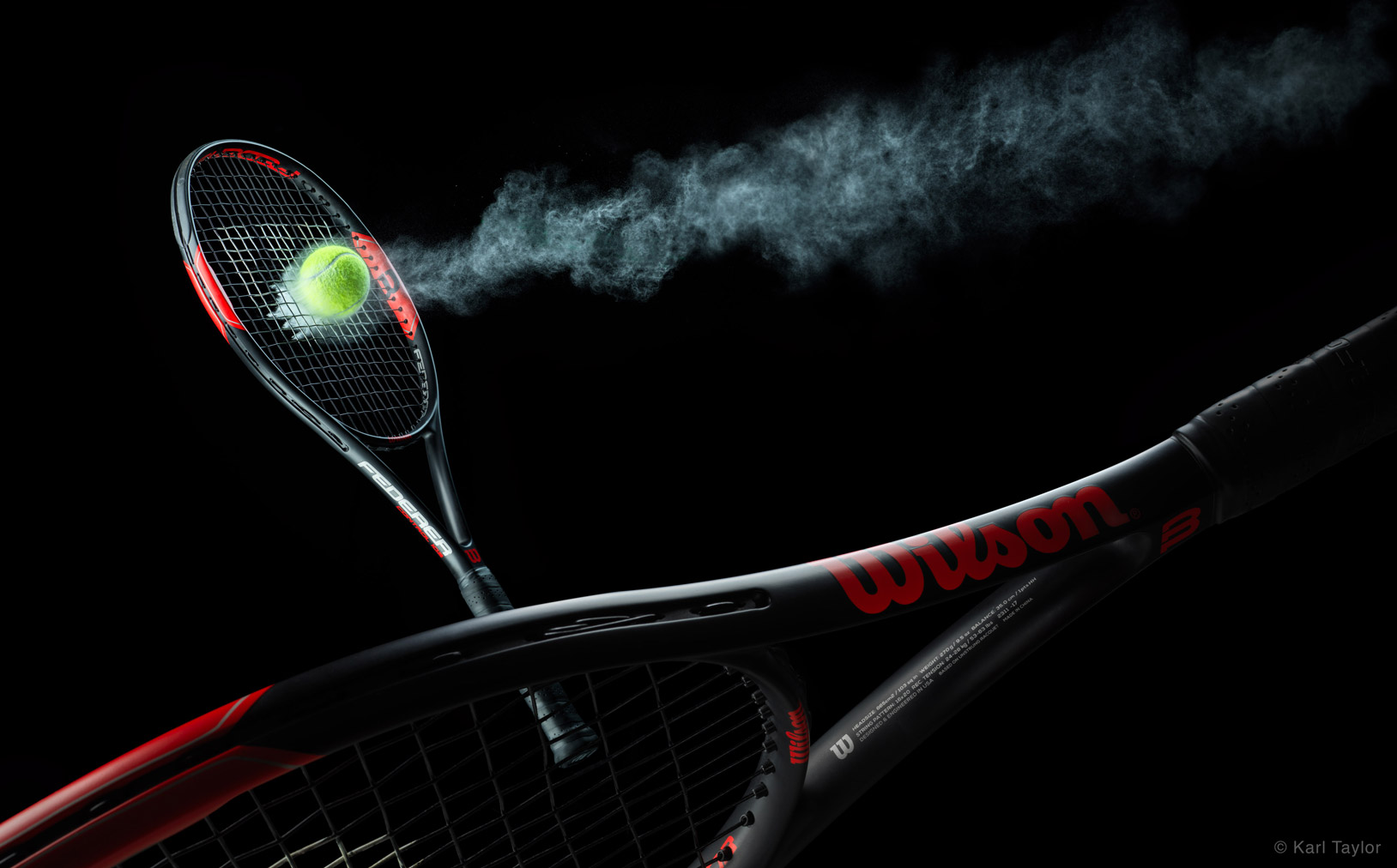 Wilson tennis racket with tennis ball on black background